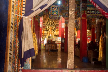 A veiw into a prayer hall while monks chant.