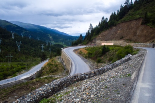 At the higher altitudes, vehicles have reduced horspower because of the thinner air. So the roads can't be too steep. This results in beatiful switchbacks winding their way over the pass.